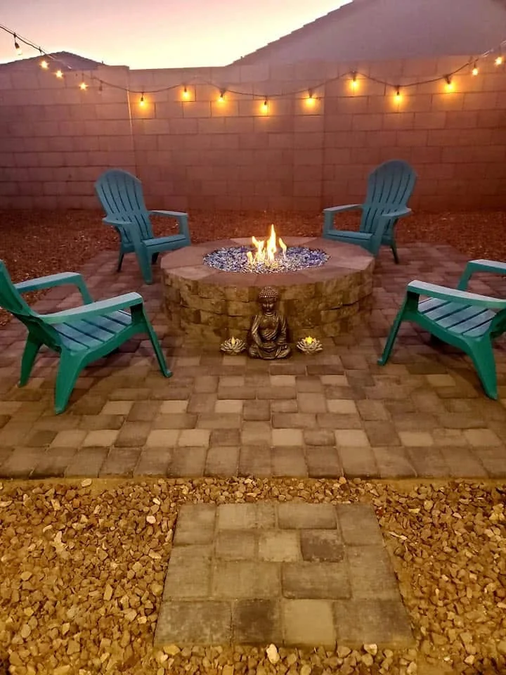 Circular fire pit on a paver patio with outdoor chairs